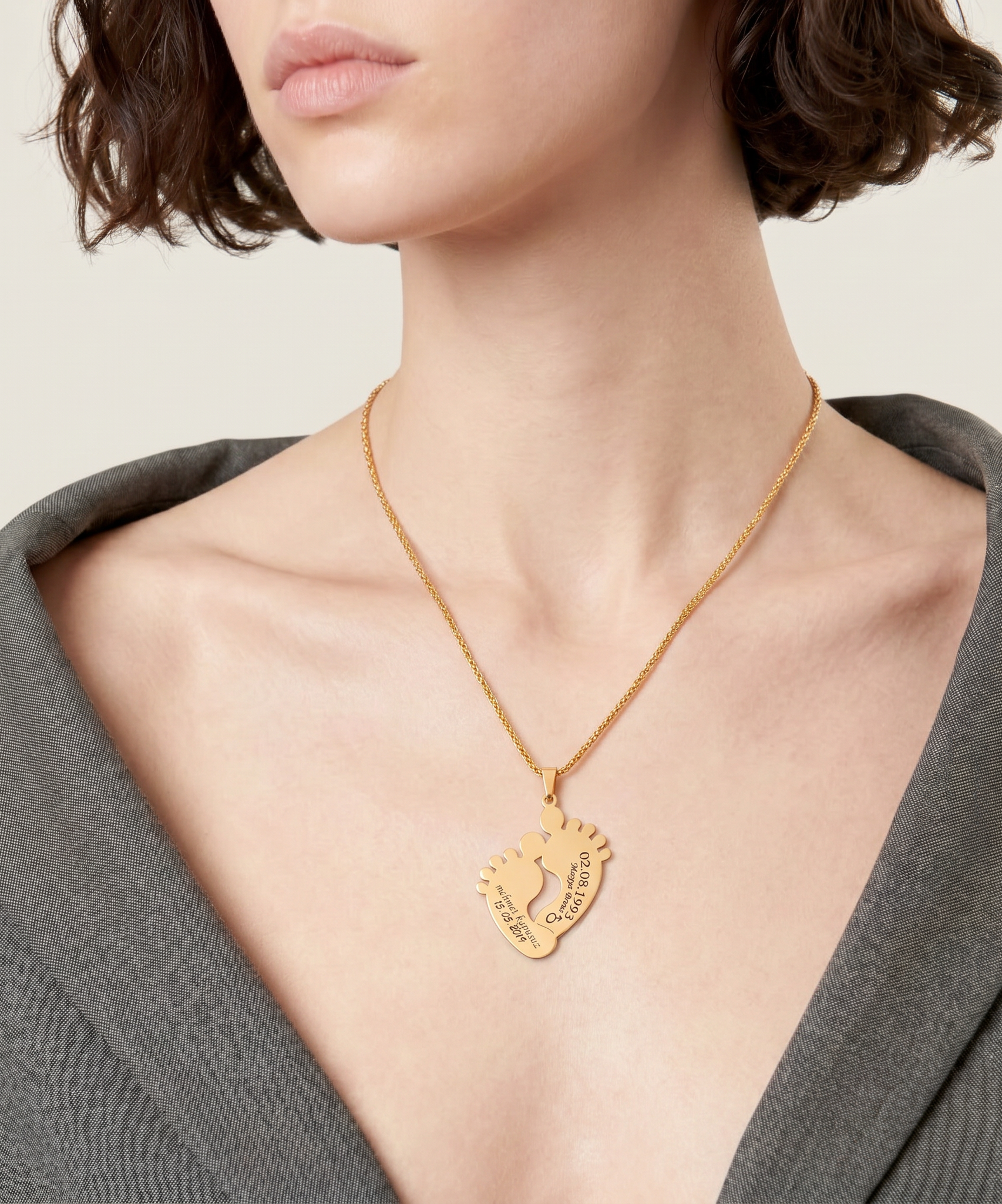 Personalized "Baby Foot Steps" Necklace worn by a human model