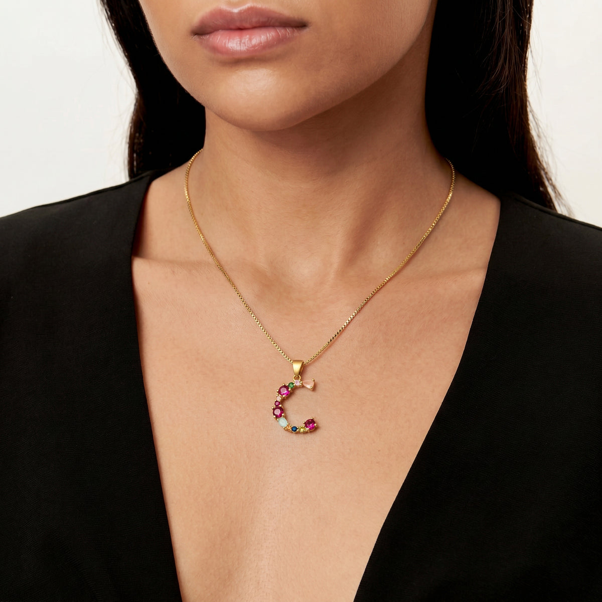 Decorated Gemstone Initial Letter Necklace worn by a human model